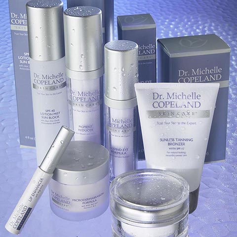 Package design for Dr. Michelle Copeland skin care products arranged on a glass table.